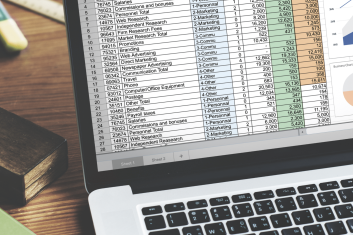 closeup hands using computer laptop with screen showing analysis data min 1 353x235 -